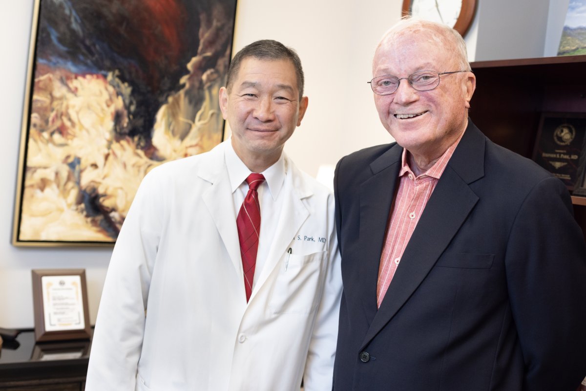Dr. Park and John Reid stand side by side smiling