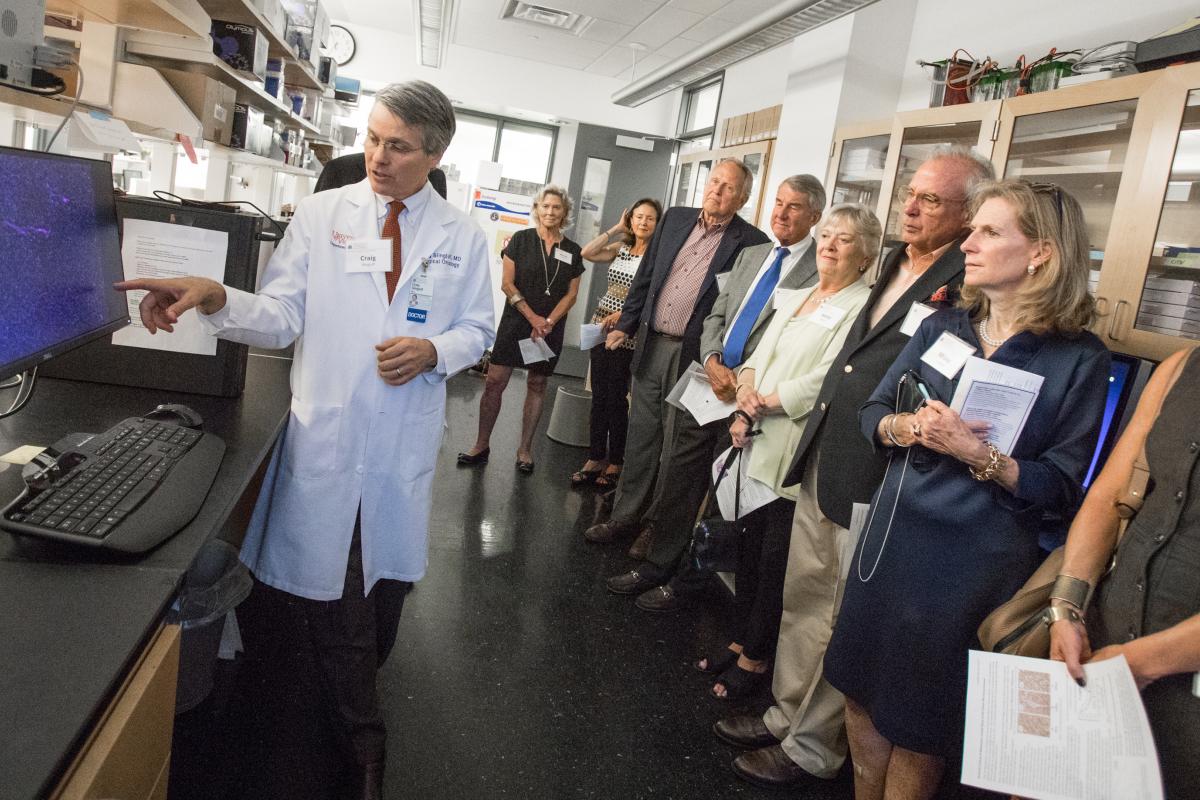 Tour attendees look on as Dr. Craig Slingluff describes recent cancer discoveries.