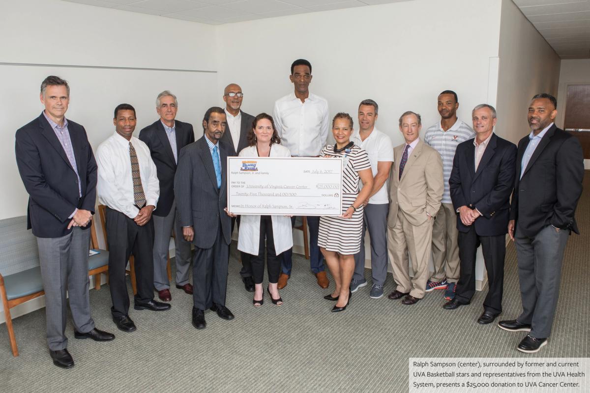 Ralph Sampson (center) surrounded by current and former UVA Basketball stars and representitives from the UVA Health System.